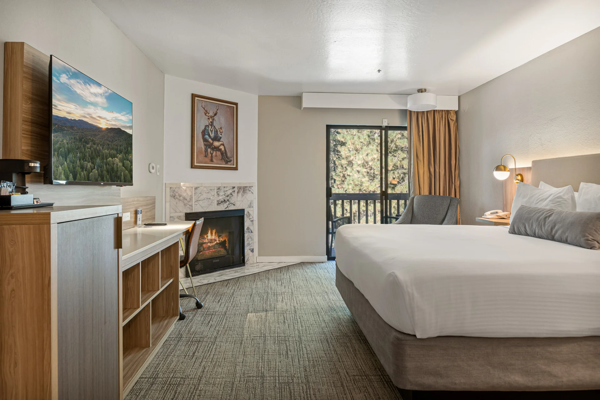 king bed, fireplace, desk, and TV with curtain open